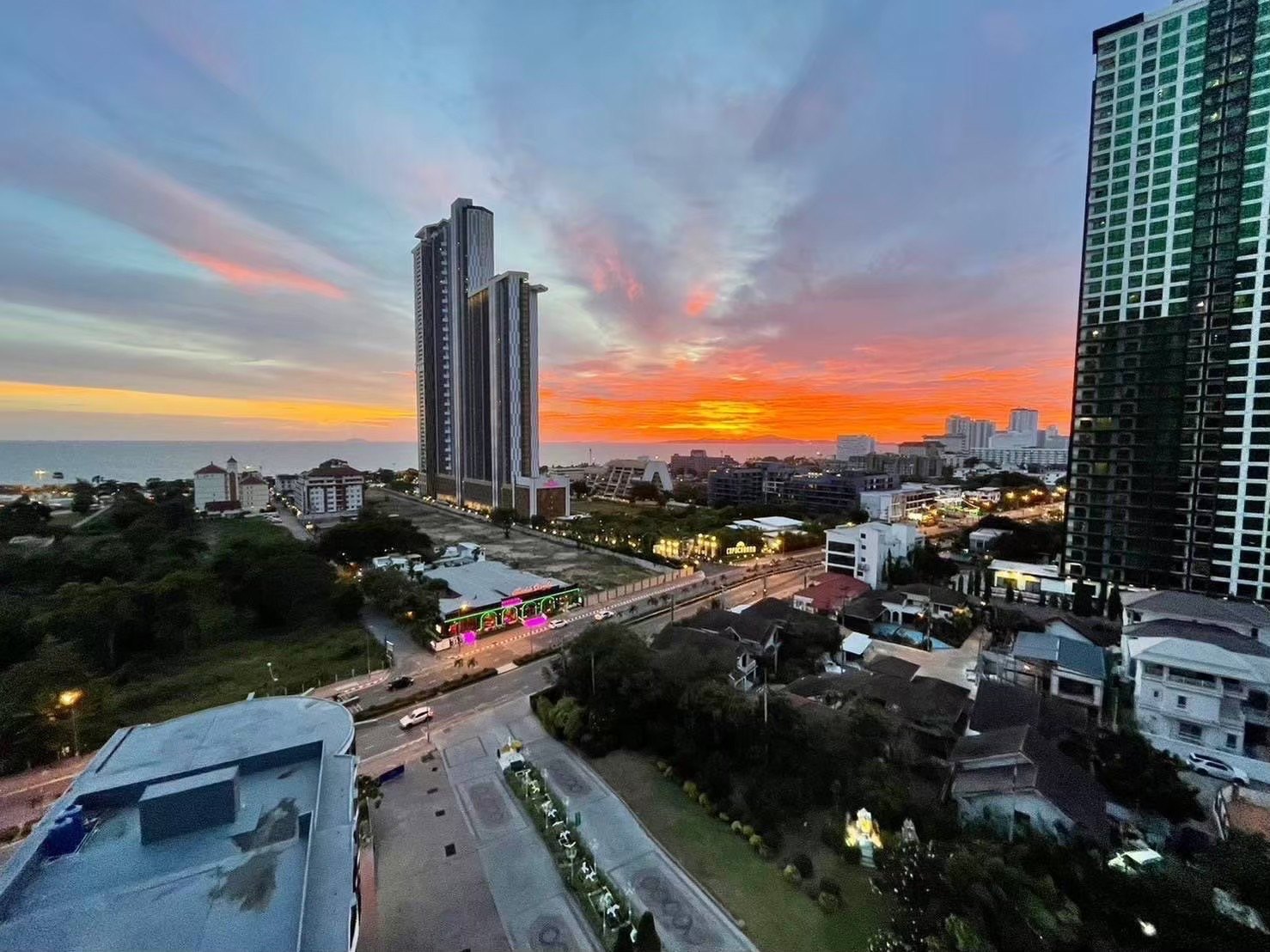 Twin towers of the Jomtien beachfront condominium at sunset over Pattaya bay